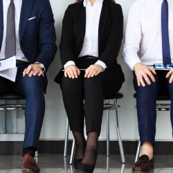 Business people waiting for job interview. Four candidates competing for one position